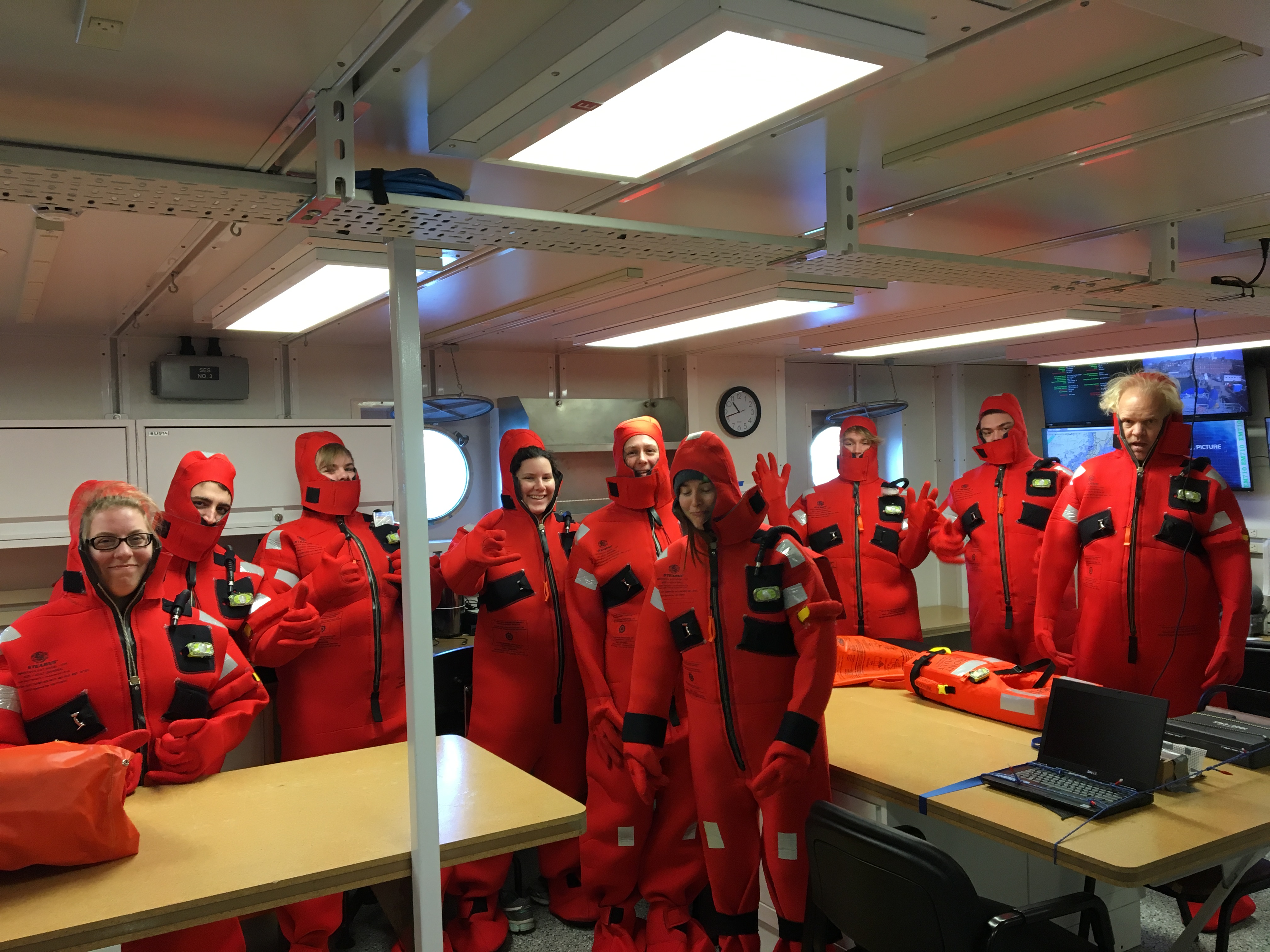team in ocean emergency suit